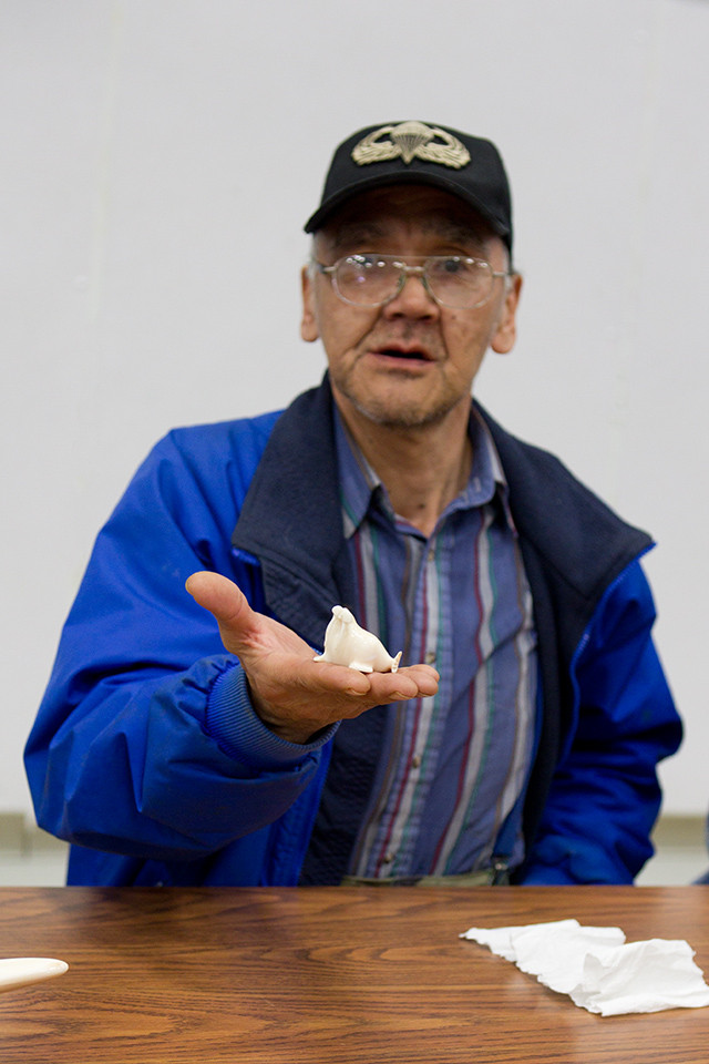 Archie Hank Slwooko, carver, and one-piece ivory walrus, marked AHS. Gambell, St. Lawrence Island.