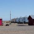 Gambell "street scene." Note gravel everywhere making it hard to walk. Allegedly it was all earth until the ubiquitous All Terrain Vehicles (ATVs) caused all the dirt to fly away, leaving only the stones.