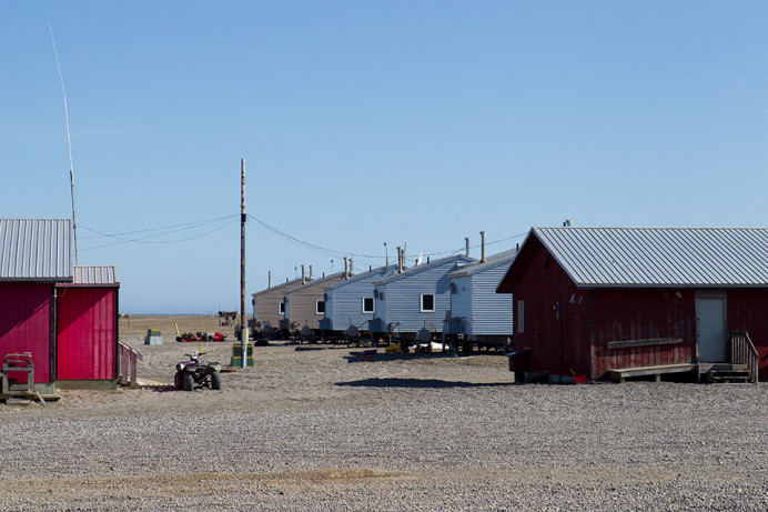 Gambell "street scene." Note gravel everywhere making it hard to walk. Allegedly it was all earth until the ubiquitous All Terrain Vehicles (ATVs) caused all the dirt to fly away, leaving only the stones.