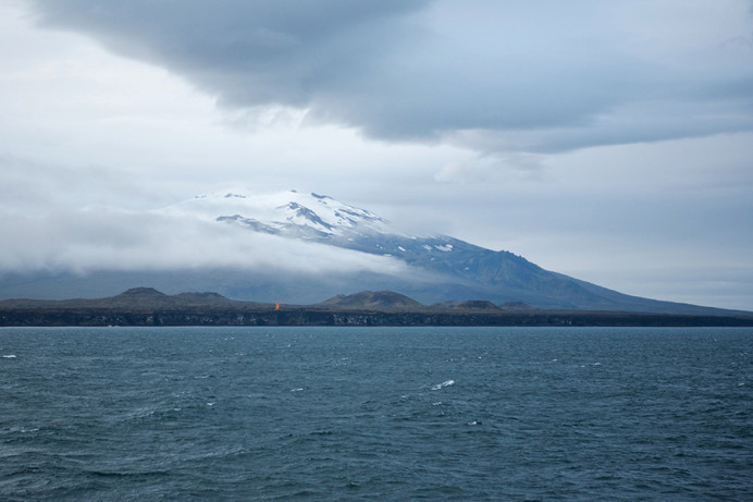 Snaefellsnes Peninsula, West Iceland, shortly after sunrise with Snaefellsjokull (glacier) coming out of the fog. Jules Verne's Journey to the Center of the Earth used Snaefellsjokull as the entry portal for the expedition to the earth's core.